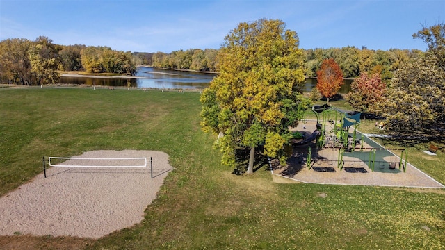 surrounding community featuring a playground, a water view, a yard, and volleyball court