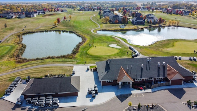 aerial view with a residential view, a water view, and golf course view