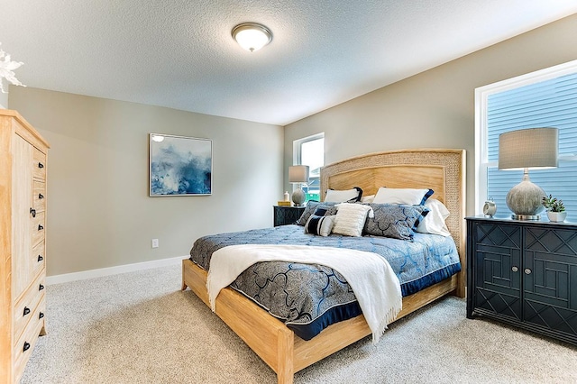 carpeted bedroom with a textured ceiling and baseboards