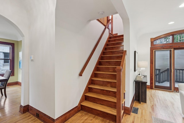 2410 Irving Ave S, Minneapolis, MN 55405 - staircase with arched walkways, wood-type flooring, baseboards, and recessed lighting