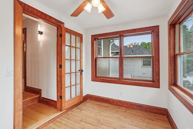 2410 Irving Ave S, Minneapolis, MN 55405 - unfurnished room featuring light wood-type flooring, healthy amount of natural light, baseboards, and a ceiling fan