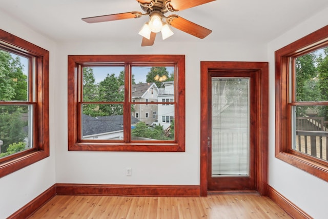 2410 Irving Ave S, Minneapolis, MN 55405 - unfurnished room featuring baseboards, light wood-style flooring, and a ceiling fan