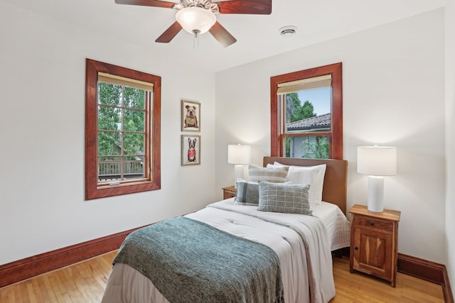 2410 Irving Ave S, Minneapolis, MN 55405 - bedroom with baseboards, light wood finished floors, and a ceiling fan
