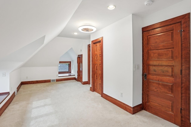 2410 Irving Ave S, Minneapolis, MN 55405 - additional living space with light colored carpet, vaulted ceiling, baseboards, and recessed lighting