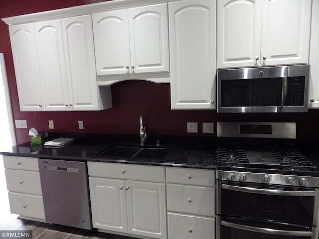 kitchen featuring stainless steel appliances, white cabinetry, and a sink