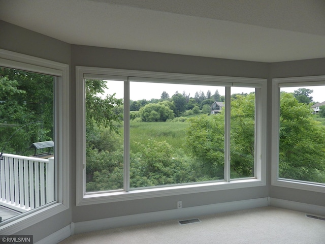 unfurnished sunroom with visible vents