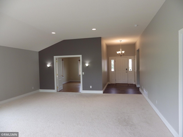 foyer entrance with baseboards, lofted ceiling, an inviting chandelier, carpet, and recessed lighting