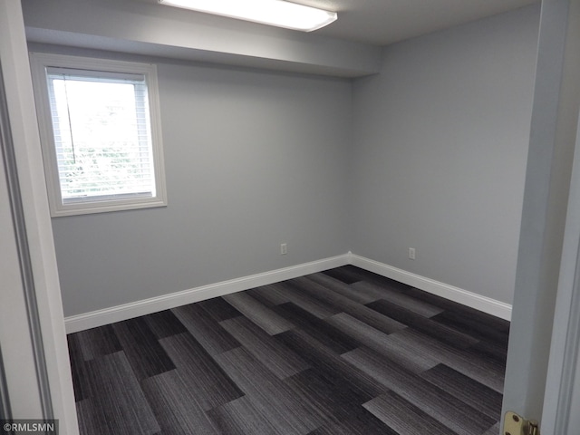 spare room featuring baseboards