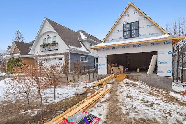 view of front of house featuring board and batten siding, an outbuilding, and an attached garage