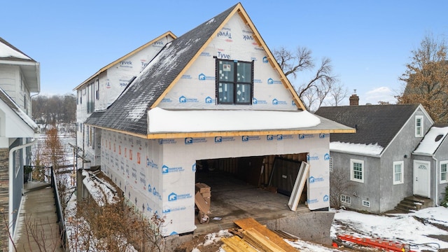 view of front of house with roof with shingles and a chimney