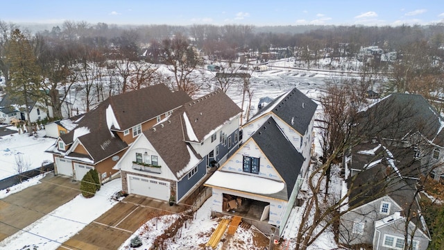 snowy aerial view featuring a residential view