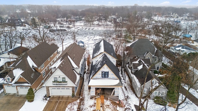 snowy aerial view with a residential view