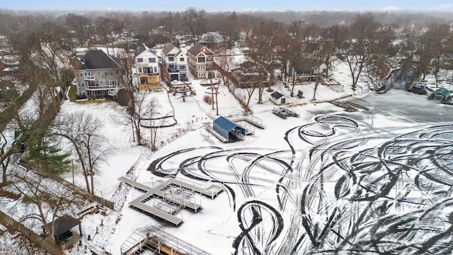 snowy aerial view featuring a residential view