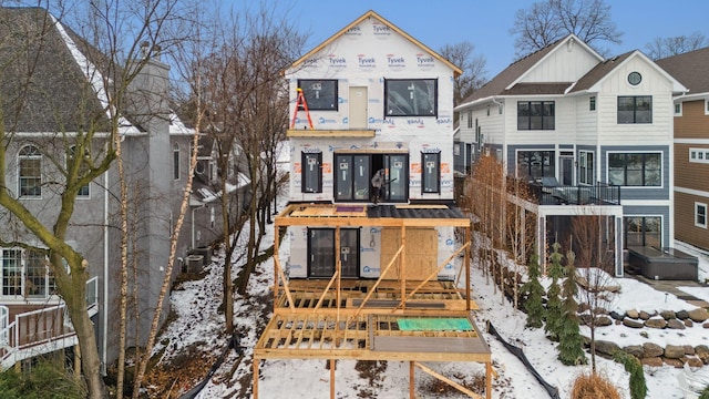 view of snow covered rear of property