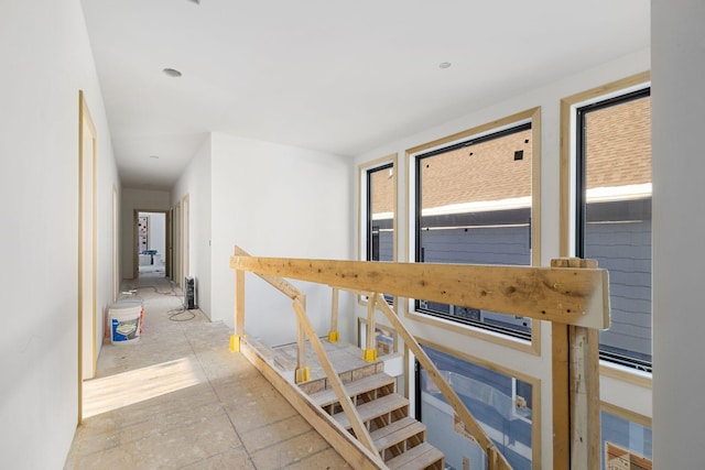 corridor with plenty of natural light and an upstairs landing