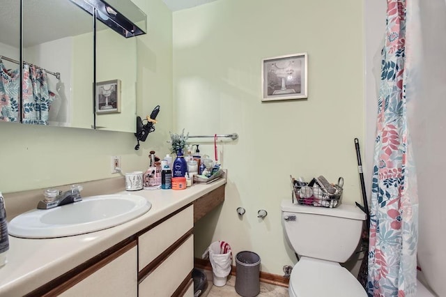 bathroom with tile patterned flooring, toilet, and vanity