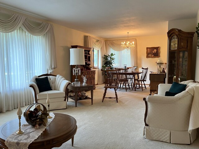 living room featuring an inviting chandelier and light carpet