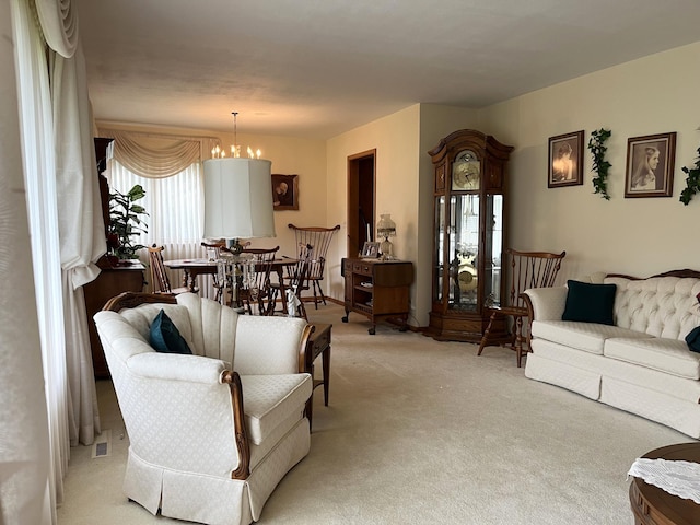 living room with an inviting chandelier and light colored carpet