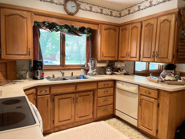 kitchen with dishwasher, tasteful backsplash, sink, and range