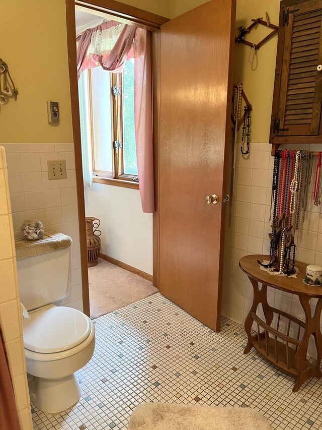 bathroom with tile walls, tile patterned flooring, and toilet