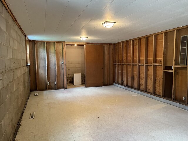 basement with light tile patterned flooring