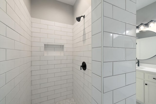 bathroom with vanity and tiled shower