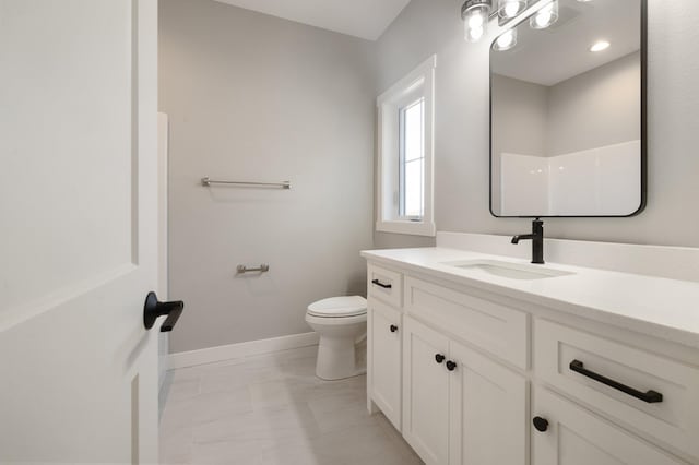 bathroom with vanity, a shower, and toilet