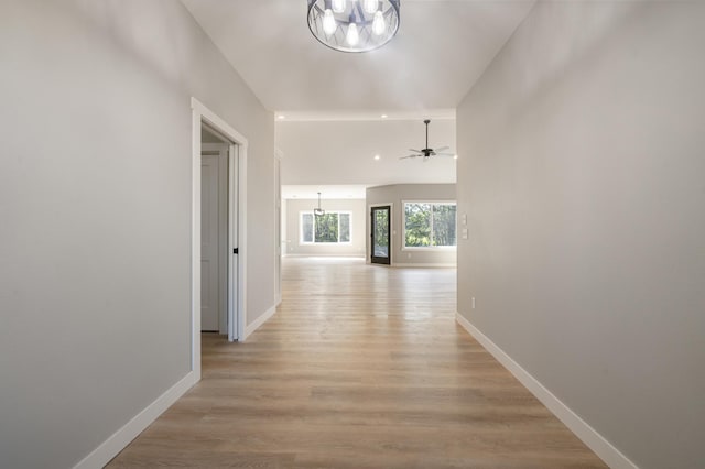 hall featuring a chandelier and light hardwood / wood-style flooring