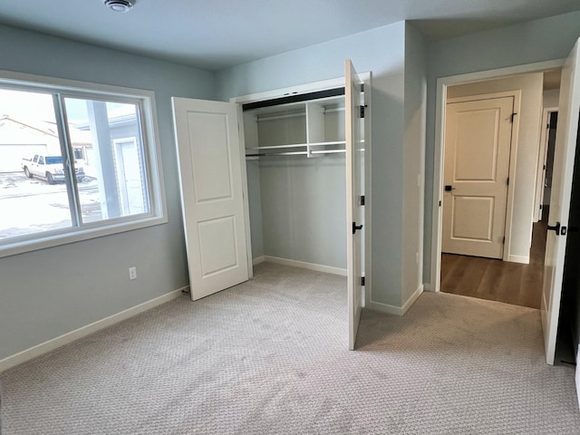 unfurnished bedroom with carpet flooring and a closet