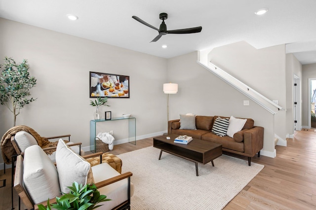 living room featuring ceiling fan and light wood-type flooring