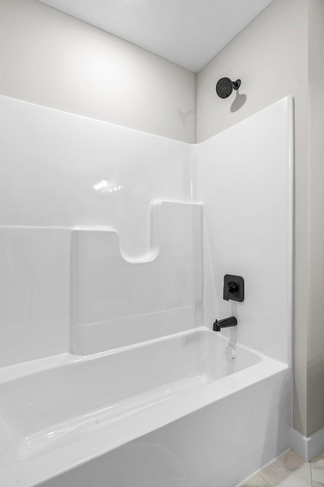 bathroom featuring tile patterned floors and shower / washtub combination