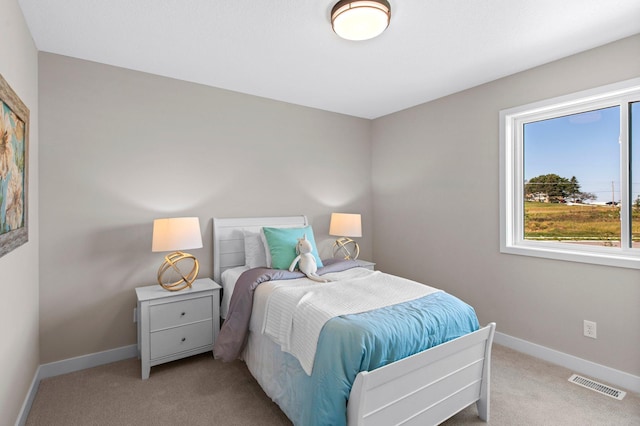 bedroom with light colored carpet