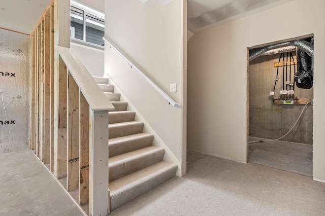 stairway featuring concrete flooring