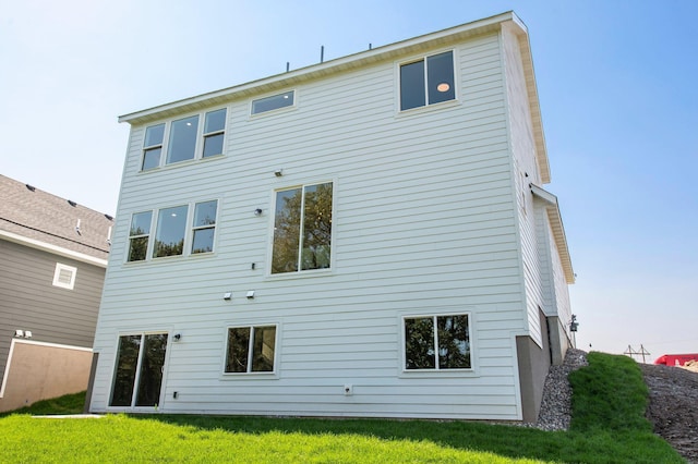 rear view of property with a lawn