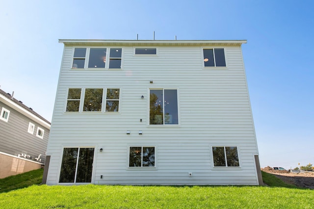 rear view of house with a yard