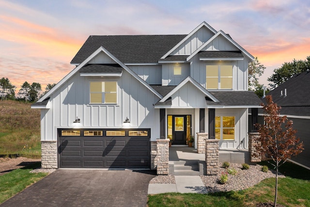 view of front of home with aphalt driveway, a garage, board and batten siding, and a shingled roof