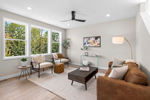 living room with ceiling fan and light hardwood / wood-style floors