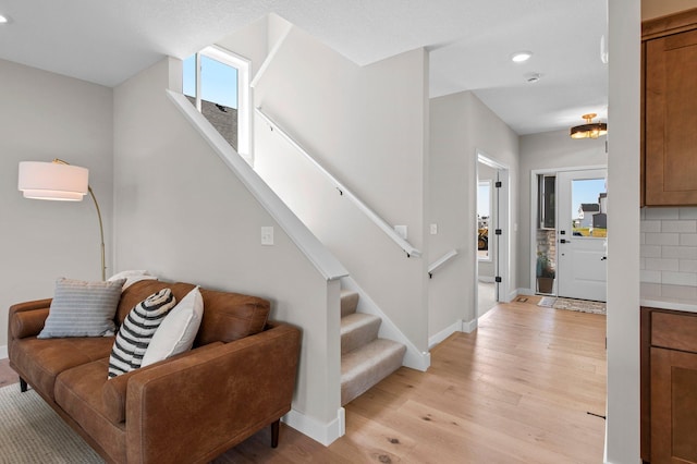 entrance foyer featuring light wood-type flooring and plenty of natural light