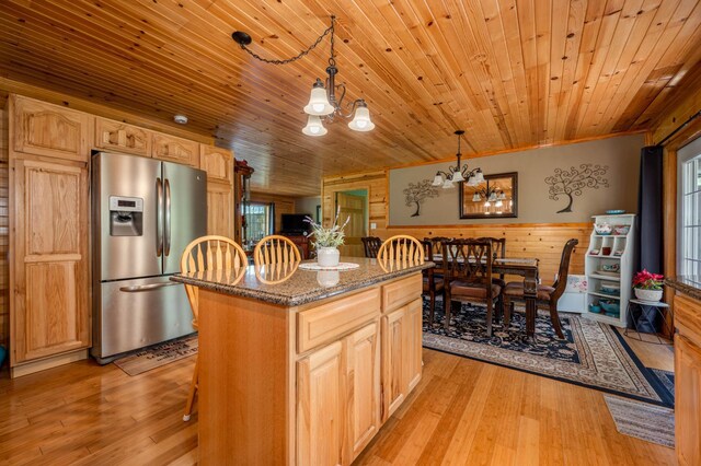 kitchen featuring pendant lighting, wooden ceiling, light hardwood / wood-style flooring, and stainless steel refrigerator with ice dispenser