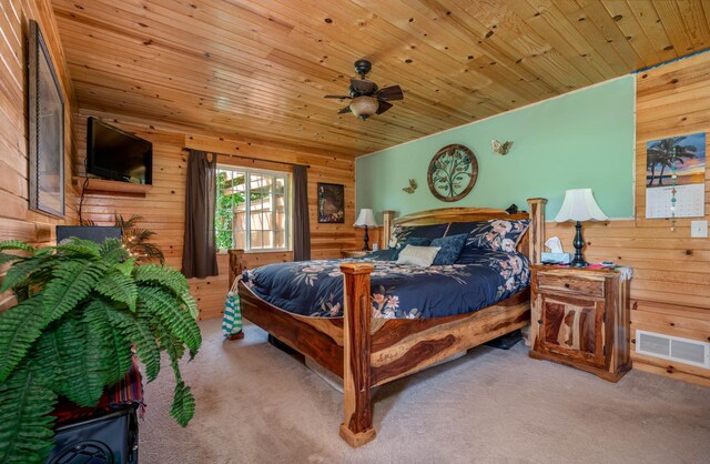 bedroom with wood walls, carpet, and wooden ceiling