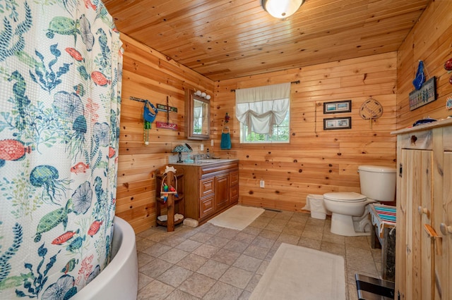 bathroom featuring tile patterned flooring, wood walls, and vanity