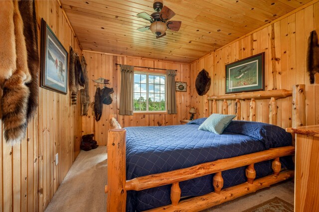 bedroom featuring wood walls, carpet, and wooden ceiling