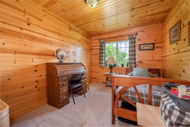 carpeted bedroom with wood walls and wooden ceiling