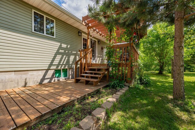 wooden terrace featuring a lawn