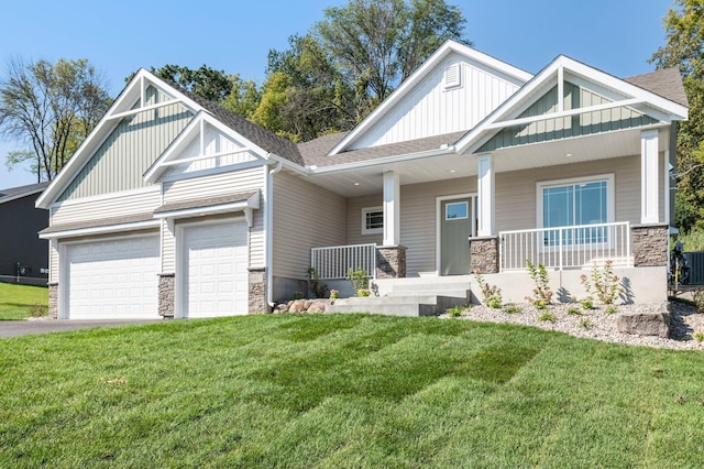 craftsman inspired home featuring central air condition unit, a front yard, covered porch, and a garage