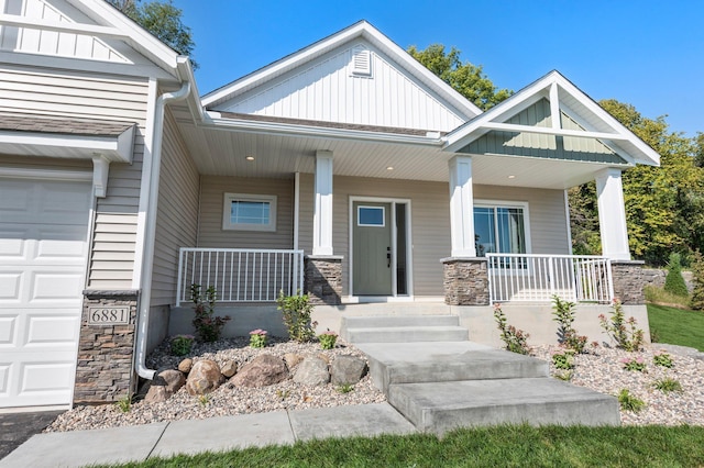 craftsman inspired home featuring a garage and covered porch