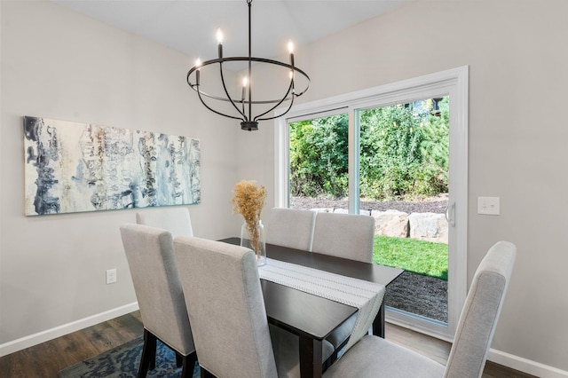 dining area with an inviting chandelier and dark hardwood / wood-style floors