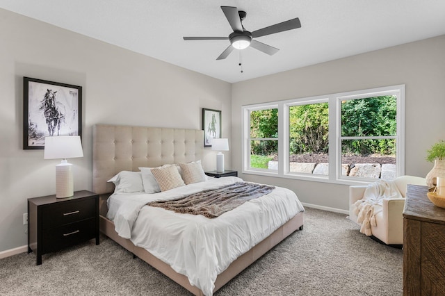 bedroom featuring light colored carpet and ceiling fan