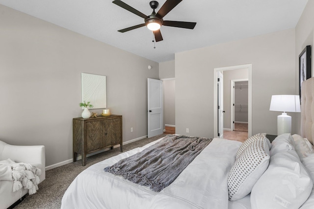 carpeted bedroom with a closet, ceiling fan, and a spacious closet