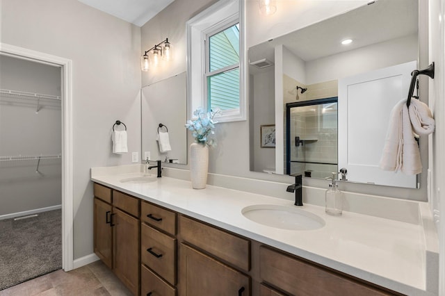 bathroom featuring vanity, an enclosed shower, and tile patterned flooring